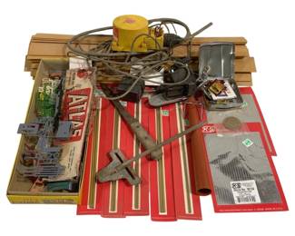 1703 - Assorted Model Building Supplies & Tools (Description): Assorted lot of model building supplies and  tools including K&S Engineering metal tubing  and sheets in original packaging, Atlas model  railroad components, wooden molding strips,  a small yellow air compressor, various hand tools including a track gauge and metal  working implements, die-cast model vehicles,  and assorted modeling accessories. A useful  collection for hobbyists working on model  railroads, scratch-building projects, or