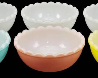 1221 - 6 Agee Pyrex Multi Color Pudding Bowls (Description): Set of six Agee Pyrex pudding bowls in  multiple colors. The collection includes  three white bowls, one turquoise blue, one  coral pink, and one yellow. Each bowl  features a distinctive scalloped rim edge. Measures 2" x 4.5".