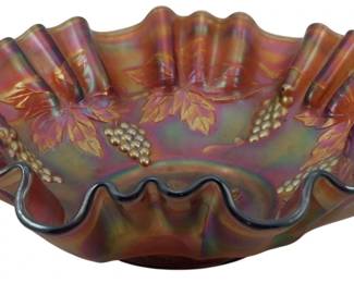879 - Vintage Fenton Amber Grape & Vine Carnival Bowl (Description): Vintage Fenton amber Grape & Vine pattern  carnival glass bowl featuring an iridescent  finish with beautiful purple, pink, and gold  hues. The bowl displays a deeply ruffled edge  with raised grape clusters and vine leaf motifs throughout. Measures 3 inches tall by  9 inches in diameter.