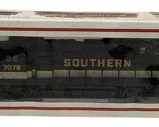 1596 - Bachmann HO Scale Southern Locomotive 8" (Description): Bachmann HO scale Southern locomotive 8"  long. The locomotive is numbered 7078 and  features the Southern railway livery in black  with gold lettering. This model features 8  wheel drive and lighted operation. Comes in original Bachmann packaging.