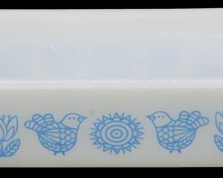 1211 - Glassbake Bird & Flower Loaf Pan 3"x10"x5" (Description): Glassbake loaf pan featuring a charming blue  bird and flower pattern on white milk glass.  The folk art-style design includes stylized  birds, tulips, and sunflower motifs in a  delicate blue print. Measures 3 inches tall by 10 inches long by 5 incheswide.