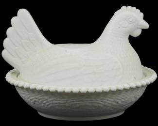 1014 - Vintage Indiana Milk Glass Hen on Nest Dish (Description): Vintage Indiana milk glass hen on nest  covered dish. The piece features a detailed  hen-shaped lid with sculpted feather details  resting atop a basket-weave textured base  with a beaded rim edge. Classic white milk glass construction. Measures 5 1/2"x 7" x 5".