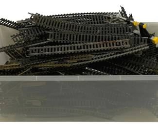 1034 - Plastic Tote Full of HO Scale Train Tracks (Description): A plastic tote full of HO scale train tracks.  The collection includes an assortment of  track pieces suitable for model railroad  layouts.