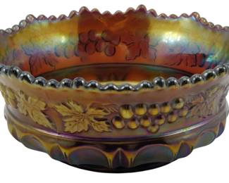 728 - Vtg Northwood Amethyst Grape & Cable Bowl (Description): Vintage Northwood amethyst Grape & Cable  pattern carnival glass bowl. This beautiful  piece features the classic grape and leaf  motif in relief around the exterior with an  iridescent finish displaying rich purple, gold, and blue tones. The bowl has a  distinctive beaded or ball-edge rim and rests  on a decorative footed base. Measures 2  inches tall by 5 inches in diameter.