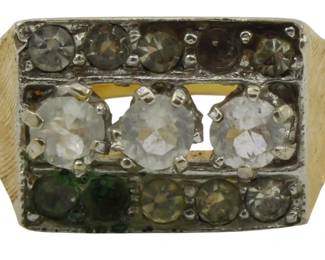 814 - 18kt Gold Ring w/ Multi-Stone Setting Size 9 (Description): 18kt gold ring featuring a rectangular  setting with multiple stones arranged in  three rows. The center row displays three  larger clear stones in prong settings,  flanked by rows of smaller accent stones including what appears to be green and  champagne-colored stones. The band features a  textured brushed finish. Size 9. Weight:  0.23oz.