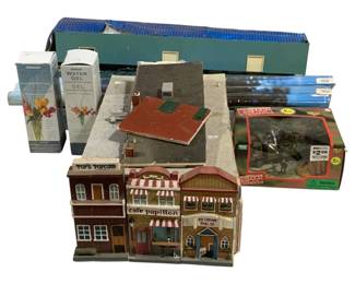 1704 - Assorted Model Buildings & Collectibles Lot (Description): Assorted lot of items including model train  buildings featuring a street scene with Pop's  Popcorn, Cafe Papillon, and Ice Cream Parlor  storefronts; additional model building  structures; a boxed Military Zone toy set; Panacea Water Gel floral arrangement  supplies; decorative poster tubes; and other  miscellaneous collectible items.