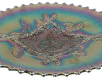 734 - Dugan Cobalt Apple Blossom Twigs Glass Dish (Description): Vintage Dugan Cobalt Blue Apple Blossom Twigs  carnival glass dish featuring iridescent  finish with beautiful purple, blue, and  golden hues. The pressed glass design  showcases raised apple blossom branches radiating from a central butterfly motif. The  dish features a distinctive sawtooth or  crimped edge. Measures 9 inches in diameter.