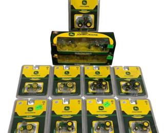 1670 - 11pc John Deere 1/87 Scale Die-Cast Tractors (Description): Collection of eleven John Deere 1/87 scale  die-cast tractors. The lot includes two boxed  John Deere Tractor Series sets containing  multiple models, along with nine individually  carded tractors featuring various classic and modern John Deere models including the  Model D, Waterloo Boy, GP Tractor, 50 Series,  Model B, and 4420 tractors. All pieces  remain in their original packaging with the  distinctive green and yellow John Deere