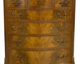 7790 - Serpentine Front Mahogany Highboy Chest (Description): A handsome English serpentine front highboy  chest crafted in flame mahogany with  beautiful figured grain throughout. This  four-drawer chest features a distinctive  upper section with a center cabinet flanked by two small drawers on each side, above four  graduated full-width serpentine drawers.  Adorned with ornate brass bail pulls and  escutcheons in a Chippendale style. The piece  rests on elegant bracket feet and displays