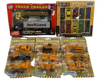 1025 - 5pc Lot Die Cast Cars & Trucks (Description): A 5-piece lot of die cast cars and trucks.  The lot includes a variety of toy vehicles  including a truck trailer set, a Motor World  car set, and construction vehicle sets. All  items are new in original packaging.