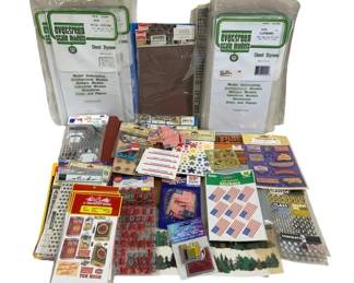 1656 - Assorted Crafting & Model Building Supplies (Description): Assorted lot of crafting and model building  supplies. Includes Evergreen Scale Models  sheet styrene for model railroading,  architectural models, military models, and  miniatures. Also features various sticker sheets including American flag designs,  patriotic themes, alphabet letters,  graduation and school-themed stickers.  Contains decorative flag picks, paper  crafting supplies, and additional