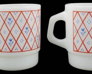 1131 - Pr Termocrisa Red Lattice Blue Flowers Mugs (Description): Pair of Termocrisa milk glass stackable mugs  featuring a red lattice pattern with blue  tulip flowers and dot accents. These vintage  mugs display the classic Fire-King style  stacking design with D-shaped handles. Each mug measures 3.5 inches tall.