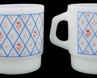 1140 - Pr Termocrisa Blue Lattice Red Flower Mugs (Description): Pair of vintage Termocrisa milk glass  stacking mugs featuring a charming blue  lattice pattern with red tulip flowers and  dot accents. These classic mid-century mugs  are in the iconic Fire-King style stackable design with D-shaped handles. Each mug  measures 3.5 inches tall.