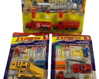 1636 - Express Wheels Diecast Metal Vehicle Playsets (Description): Lot of three vintage toy playsets in original  packaging. The collection includes two  Express Wheels Diecast Metal Value Sets  featuring construction and fire station  themes with vehicles and accessories, plus one Emergency Rescue playset with fire truck  and emergency vehicles. Each set contains  die-cast metal vehicles with free wheels and  tampo printing, along with various play  accessories including traffic signs, figures,
