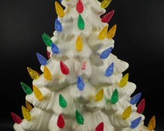 781 - Vintage White Ceramic Christmas Tree 17in (Description): Vintage white ceramic Christmas tree with  colorful plastic light pegs in red, blue,  green, yellow, and orange. Many pegs are  missing throughout the tree. Features a  classic tiered branch design with a pointed star topper. Measures 17 inches tall, 2  piece. Used as is electric/electronic/mechanical  item. No guarantee all components, untested.