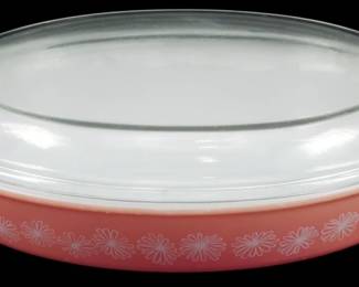 1122 - Pyrex Pink Daisy Divided Casserole w/ Lid (Description): Vintage Pyrex Pink Daisy casserole dish with  clear glass lid. This mid-century piece  features the classic pink body with white  daisy floral pattern. The divided oval  casserole includes its original clear glass domed lid with tab handles on each end.