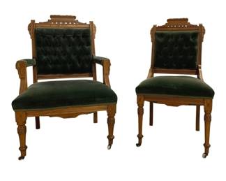 7707 - Pair Eastlake Parlor Chairs (Description): Eastlake-style carved frames with decorative  pierced gallery crests. The chairs are  upholstered in deep green velvet with tufted  button backs. The set includes one armchair  and one side chair, both with turned front legs resting on casters. The frames display  incised decorative details throughout.  Measures 38" x 24" x 25".