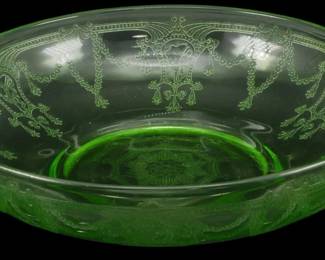 884 - Vtg Anchor Hocking Cameo Green Uranium Glass (Description): Vintage Anchor Hocking Cameo pattern green  uranium depression glass bowl. This elegant  piece features the classic Cameo design with  ornate etched patterns including swags,  medallions, and decorative scrollwork around the sides and a detailed medallion on the  base. The transparent green glass exhibits  the characteristic glow associated with  uranium glass from this era. Measures 2  inches tall by 8.5 inches in diameter.