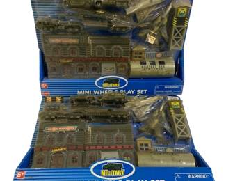 1065 - 2pc Supreme Military Mini Wheels Play Set (Description): A 2-piece lot of Supreme Mini Wheels Play  Sets featuring military themes. These sets  are new in their original boxes and include  various military vehicles, buildings, and  accessories for imaginative play.
