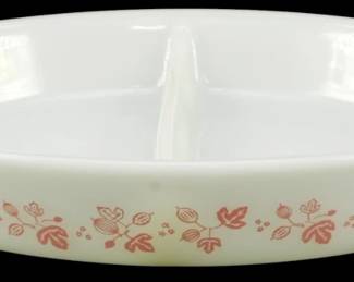 1224 - Pyrex Gooseberry Pink Divided Casserole Dish (Description): Pyrex Gooseberry Pink divided casserole dish  featuring the classic pink floral and leaf  pattern on white milk glass. This oval baking  dish has a center divider for serving two  dishes simultaneously. Measures 2" x 9" x 13".