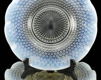 927 - 3 Anchor Hocking Moonstone Opalescent Plates (Description): Three vintage Anchor Hocking Moonstone  pattern plates featuring the distinctive  hobnail design with opalescent white edges  that transition to clear glass at the center.  Each plate displays a scalloped rim and a radiating sunburst pattern in the center  well. The Moonstone pattern was produced from  1941-1946 and is characterized by its milky  white opalescent coloring around the edges.  Each plate measures 11 inches in diameter.