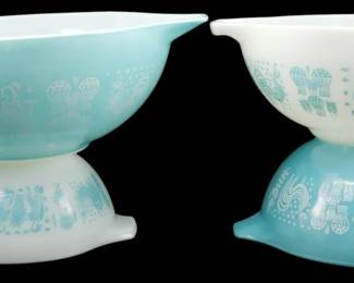 1175 - Pyrex Butterprint Turquoise Mixing Bowls Set (Description): Set of four Pyrex Butterprint turquoise  mixing bowls featuring the classic  Amish-inspired pattern with pastoral scenes.  The set includes nesting Cinderella-style  bowls with pour spouts and tab handles in both turquoise with white print and white  with turquoise print colorways. Measures  4.5"x13"x10".