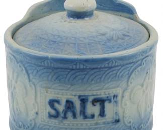 594 - Vintage Hanging Stoneware Salt Crock 6"x5.5" (Description): Vintage hanging stoneware salt crock with  lid. Features embossed decorative patterns  and "SALT" lettering on the front. Includes a  hole for wall mounting. Measures 6 inches by  5.5 inches.