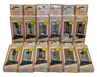 1044 - 12 Model Power Railroad Signals (Description): A collection of twelve Model Power railroad  signals. These HO scale signals feature  prewired switches and brass construction  details. The lot includes various signal  styles in their original packaging.
