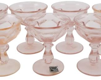 745 - 8 Vtg Imperial Pink Glass Champagnes 5" (Description): Set of eight vintage Imperial champagne coupe  glasses in a delicate pink depression glass.  Each glass features an elegant Provincial or  thumbprint-style pattern with a distinctive  twisted or knotted stem on a circular foot. One glass retains the original Imperial Glass  paper label. Each measures 5 inches in  height.
