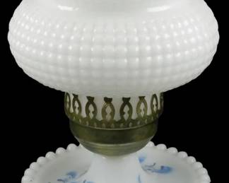 651 - Milk Glass Lamp 8" (Description): Milk glass lamp measuring 8 inches in height.  Features a decorative hobnail pattern on the  globe with a ruffled rim, a pierced brass  collar, and a base with blue hand-painted  floral design and beaded edge. Used as is electric/electronic/mechanical  item. No guarantee all components, untested.