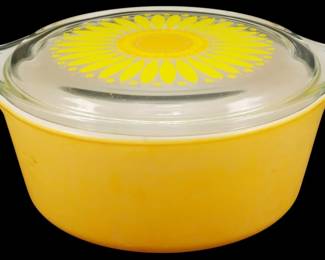 1154 - Pyrex Sunflower .5 Pint Casserole 3"x8"x6" (Description): Pyrex Sunflower pattern casserole dish in the  half pint size. Features a cheerful yellow  exterior with a clear glass lid decorated  with a bold yellow and orange daisy design.  The dish has two integrated handles for easy carrying. Measures 3 inches tall by 8 inches  wide by 6 inches deep.