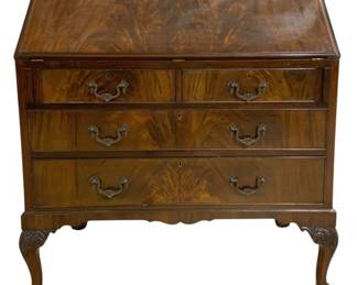 7736 - Chippendale Style Mahogany Secretary Desk (Description): Chippendale style secretary desk in flame  mahogany with a slant front lid. The piece  features two small drawers over two  full-width graduated drawers, all with ornate  brass bail pulls and escutcheons. The desk rests on carved cabriole legs terminating in  ball and claw feet, with a shaped apron along  the base. Measures 42"x36"x20".