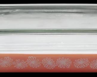 1149 - Pyrex Flamingo Pink Daisy Casserole w/ Lid (Description): Pyrex Flamingo Pink Daisy rectangular  casserole dish with clear glass lid. The dish  features a lovely pink exterior decorated  with white daisy flowers in a repeating  pattern along the sides, with a white interior. Measures 3" x 6.5" x 11".