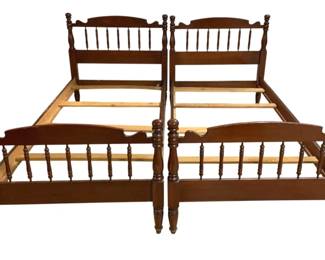 7688 - Pair Vintage Spindle Twin Beds 41"x41"x41" (Description): Pair of twin bed frames crafted in rich  cherry-toned wood featuring classic spindle  design. Each bed showcases turned posts with  decorative finials, spindle headboards and  footboards with curved top rails, and sturdy turned legs. The frames include wooden side  rails and slat supports. Traditional Colonial  or Early American style. Each bed measures  41 inches in height, width, and length.