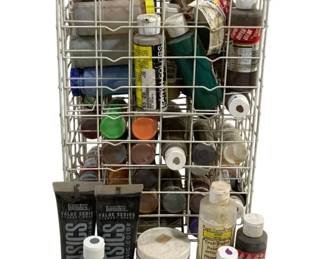 1697 - Lot Assorted Paints & Holder 18"x10"x7" (Description): A lot of assorted paints and art supplies  housed in a white wire storage caddy with  carrying handle. The collection includes  various brands such as Liquitex Basics  acrylic paints, FolkArt, Apple Barrel, and Krylon Clear Glaze. Paints range in colors  and sizes, suitable for crafting and art  projects. The wire holder measures 18" x 10"  x 7".