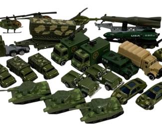 1571 - Lot Military Die-Cast Vehicles (Description): A collection of military die-cast vehicles  featuring an assortment of army-themed pieces  including helicopters, tanks, trucks, jeeps,  missile launchers, and armored vehicles. The  vehicles are predominantly finished in olive drab green and camouflage patterns typical  of military equipment. The lot includes  various scales and styles of military  transport and combat vehicles.