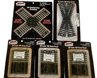 1682 - 5 pc Lot Atlas HO Scale Train Accessories (Description): A 5 piece lot of Atlas HO scale train track  accessories. The lot includes one HO  Custom-Line 90 degree crossing (Item #176,  Code 100, Nickel Silver), one 30 degree  crossing (Item #839, Code 100, Nickel Silver), and three packages of track bumpers  (Item #843, Code 100, Nickel Silver, 2 pieces  each). All items are in original Atlas  packaging from the HO Code 100 Snap-Track  line.
