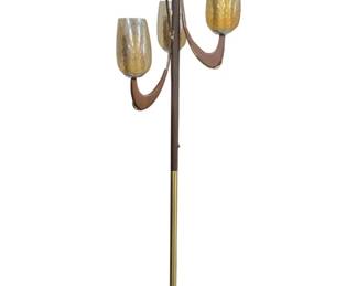 961 - Mid Century Modern Floor Lamp w/ Glass Shades (Description): Mid Century Modern floor lamp featuring a  brass and wood pole design with three  amber-tinted glass globe shades. The lamp  showcases curved wooden arms that cradle each  shade, characteristic of 1960s Danish-influenced design. The cylindrical  brass base provides stable support. Measures  71 inches tall. Used as is electric/electronic/mechanical  item. No guarantee all components, untested.
