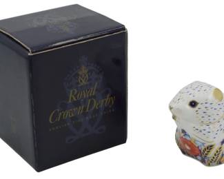 808 - Royal Crown Derby Meadow Mouse Paperweight (Description): Royal Crown Derby Meadow Rabbit paperweight  featuring the classic Imari-style decoration  with cobalt blue, red, and gold accents on  white bone china. This charming rabbit  figurine displays intricate hand-painted floral and wheat motifs. Features a gold  stopper on the base, indicating first  quality. Comes with original Royal Crown  Derby presentation box. Measures 3 inches.