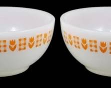1147 - Set of 4 Termocrisa Gingham Tulip Bowls (Description): Set of four Termocrisa milk glass bowls  featuring a charming orange gingham and tulip  pattern around the exterior rim. These  vintage Mexican-made bowls display a cheerful  design with alternating orange tulip motifs and checkered squares on a white milk glass  background. Measures 2 inches tall by 5  inches in diameter.
