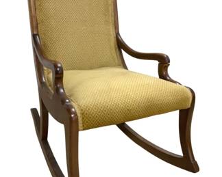 7639 - Vintage Upholstered Wood Rocking Chair (Description): Vintage upholstered rocking chair featuring a  wooden frame with gracefully curved arms and  rockers. The chair is upholstered in a  golden yellow diamond-patterned fabric on  both the seat and tall back. The warm-toned wood frame has a classic design with scrolled  arm supports. Measures 31 inches high by 24  inches wide by 19 inches deep.