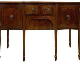 7776 - Antique English Mahogany Inlaid Brandy Board (Description): Antique mahogany sideboard server featuring  elegant Federal-style design with string  inlay accents. The piece showcases a central  drawer with brass lion head ring pulls above  an arched apron, flanked by two cabinet doors with decorative oval inlaid panels and  matching lion head hardware. The server  stands on six slender tapered legs with spade  feet. Measures 34 inches high by 48 inches  wide by 20 inches deep.