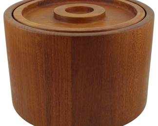 973 - Jens Quistgaard Dansk Ice Bucket 6"x9.5" (Description): Dansk Denmark wooden ice bucket featuring a  cylindrical stave construction in warm teak  with a fitted lid and recessed circular  handle. The piece exemplifies mid-century  Danish modern design with clean lines and quality craftsmanship. Measures 6 inches tall  by 9.5 inches in diameter.
