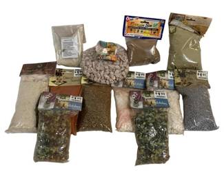 1054 - Lot Decorative Pebbles Sand & Gravel Bags (Description): A lot of decorative pebbles, sand, and gravel  bags suitable for crafts, terrariums,  aquariums, or home decor projects. The  collection includes various types and colors  of decorative stones, pebbles in assorted sizes, natural sand, and gravel materials.  Most bags appear to be retail packaged with  original labels intact.