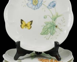 779 - 6 Lenox Butterfly Meadow Plates, 4 Patterns (Description): Set of six Lenox Butterfly Meadow plates  featuring four different patterns. The  scalloped-edge plates are decorated with  delicate botanical and nature motifs  including blue poppies, butterflies, ladybugs, and trailing vines on a white  ground. Each plate measures 9 inches in  diameter.