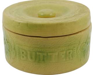 593 - Vtg Yellow Ware Stoneware Butter Crock w/ Lid (Description): The crock features embossed lettering  spelling "BUTTER" along with decorative  motifs. Measures 4 inches tall by 7 inches in  diameter.