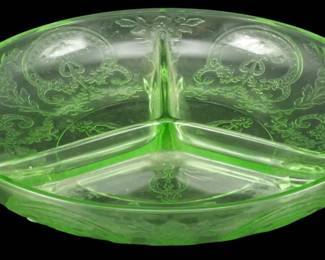 901 - Uranium Depression Glass Cameo Relish Dish (Description): Vintage uranium depression glass relish dish  in the Cameo pattern. This green glass  divided dish features three sections with a  center divider and decorative handles on each  side. The glass displays the characteristic green glow of uranium glass and is adorned  with an etched floral and scroll design  throughout. Measures 2 inches tall by 8  inches in diameter.