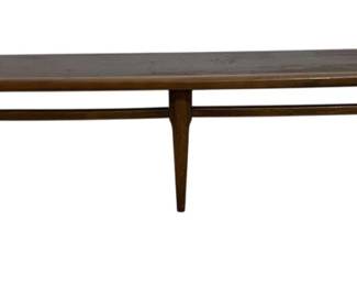 7617 - Mid-Century Lane Surfboard Walnut Coffee Table (Description): Mid-century modern coffee table featuring a  long, surfboard-style top with rounded ends.  The table is crafted in walnut with a warm  brown finish and is supported by four tapered  legs connected by stretchers. Measures 19 inches wide by 27 inches long by 14 inches  tall.