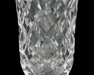 1239 - Waterford Crystal Kinsale Pattern Vase 7" (Description): Waterford Crystal vase in the Kinsale  pattern. This elegant footed vase features a  distinctive diamond-cut design throughout the  body with a flared rim and decorative  starburst cut base. Measures 7 inches in height.