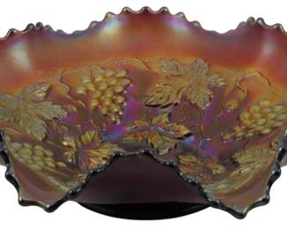 727 - Northwood Amethyst Grape & Cable Glass Bowl (Description): Vintage Northwood amethyst Grape & Cable  pattern carnival glass bowl featuring a  ruffled edge with distinctive crimped rim.  The bowl displays the classic grape and leaf  motif with iridescent finish characteristic of carnival glass. Measures 2 1/2 inches tall  by 8 inches in diameter.